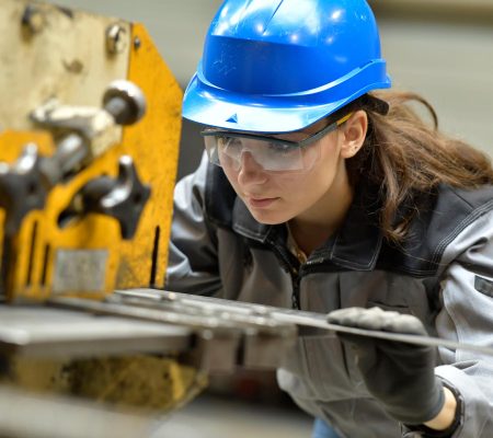 Jeune apprenti utilisant une machine d'aciérie